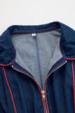 Dark blue FJØRNA denim jumpsuit with wide-leg design, topstitched details, and long sleeves.