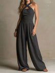 FJØRNA charcoal pinstripe halter neck wide-leg jumpsuit for women, featuring a stylish halter neckline and flowing wide-leg design.