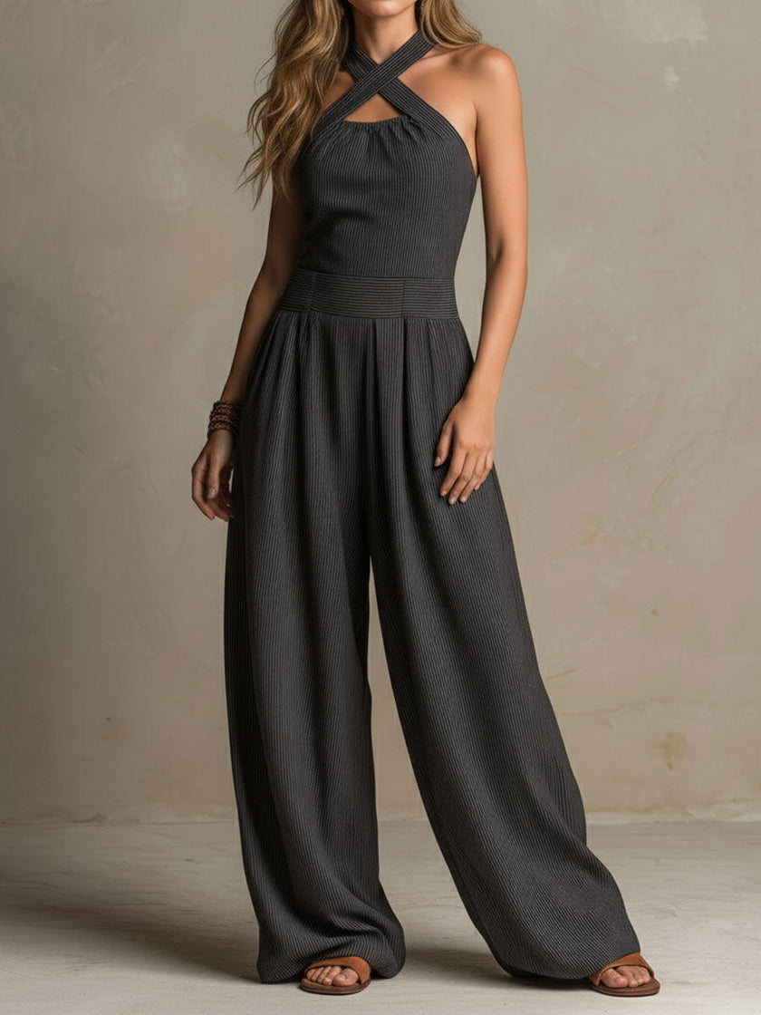 FJØRNA charcoal pinstripe halter neck wide-leg jumpsuit for women, featuring a stylish halter neckline and flowing wide-leg design.