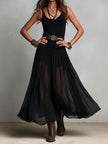 FJØRNA black maxi dress, casual style, flowing fabric, sleeveless design, full-length dress shown on a model.