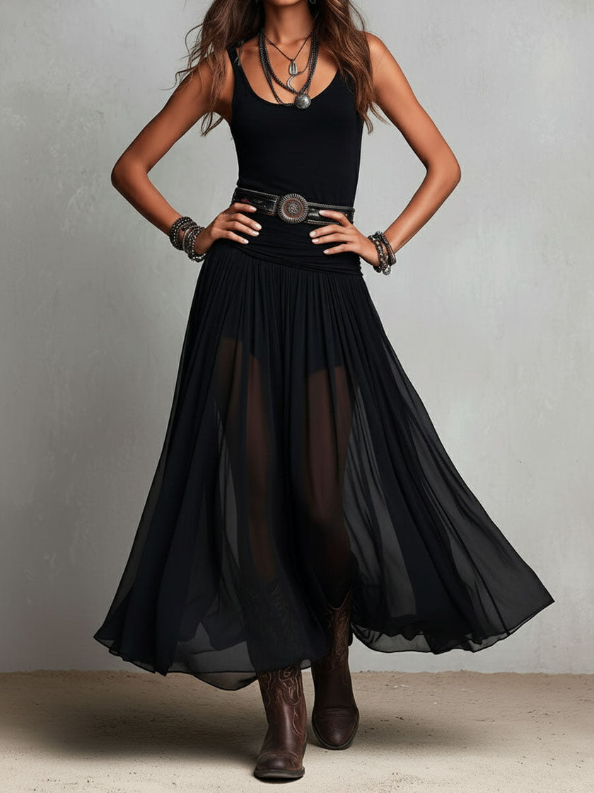 FJØRNA black maxi dress, casual style, flowing fabric, sleeveless design, full-length dress shown on a model.