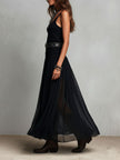 FJØRNA black maxi dress, casual style, flowing fabric, sleeveless design, full-length dress on a model.