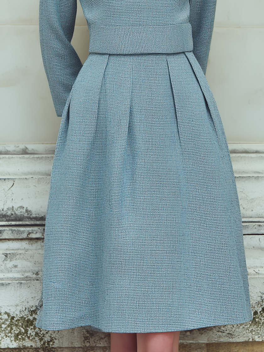 FJØRNA vintage tweed long-sleeved midi dress featuring classic pattern and tailored fit, displayed on a dress form.