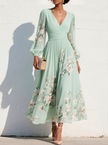 FJØRNA floral print long-sleeved V-neck pleated dress with elegant design and vibrant floral pattern, perfect for stylish occasions.