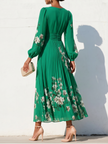 FJØRNA floral print long-sleeved V-neck pleated dress with elegant floral pattern and flowing silhouette.