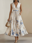 FJØRNA women's white printed V-neck sleeveless pleated dress hanging on a mannequin.