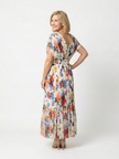 FJØRNA floral pleated summer midi dress for women, showing a colorful, flowy dress with a fitted waist and short sleeves.