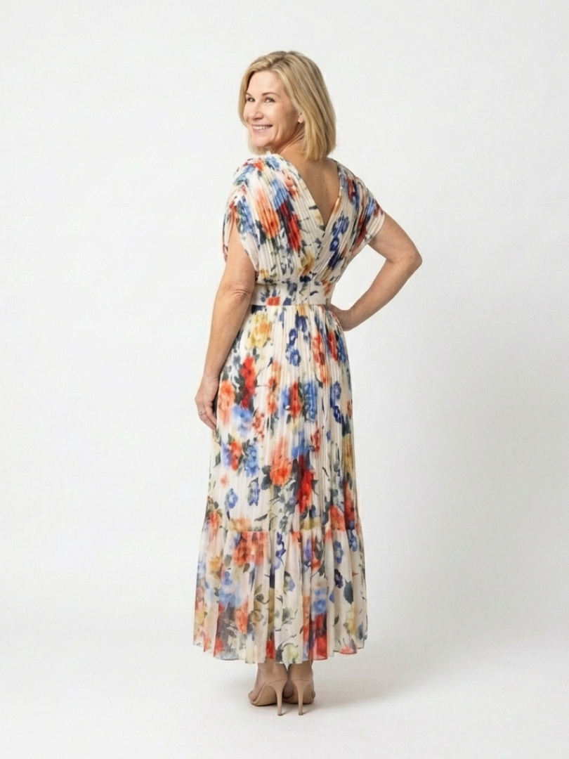 FJØRNA floral pleated summer midi dress for women, showing a colorful, flowy dress with a fitted waist and short sleeves.