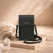 FJØRNA women's crossbody bag in tan leather, featuring adjustable strap and compact design for everyday use.