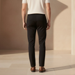 Men's FJØRNA trousers featuring classic fit, made from durable fabric, shown in a neutral color on a male model.