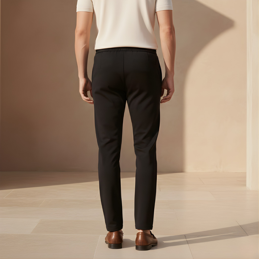 Men's FJØRNA trousers featuring classic fit, made from durable fabric, shown in a neutral color on a male model.