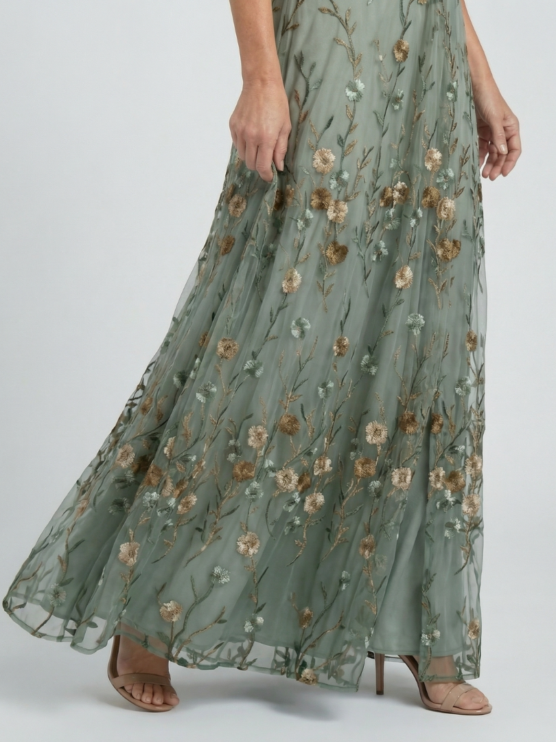 FJØRNA elegant floral maxi dress for women with halter neck, flowing fabric and vibrant floral pattern, perfect for summer occasions.