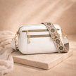 FJØRNA leather shoulder bag for women featuring a sleek design, adjustable strap, and durable brown leather material.