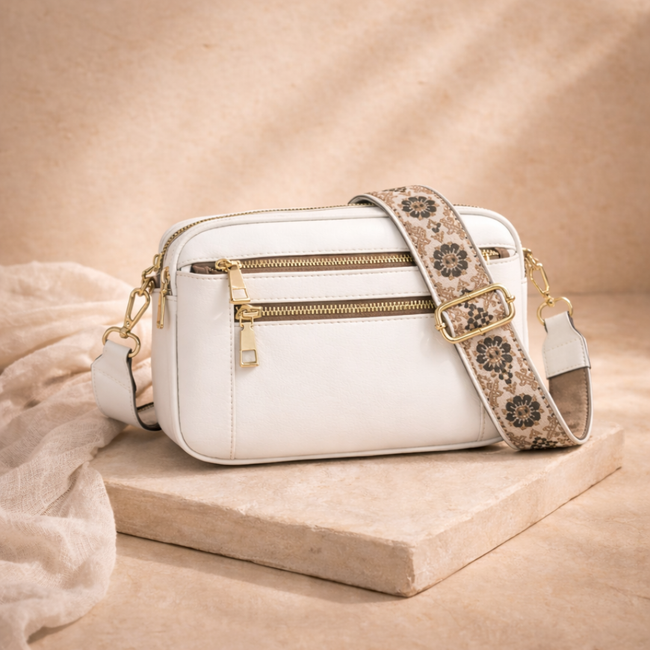 FJØRNA leather shoulder bag for women featuring a sleek design, adjustable strap, and durable brown leather material.