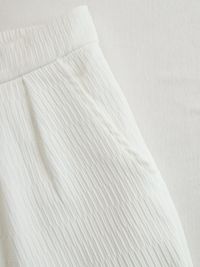 Cream textured lantern sleeve two-piece pants set by FJØRNA, featuring a stylish top and matching pants in a cozy fabric.