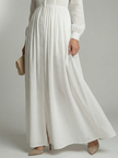 FJØRNA women's summer maxi dress with long sleeves and pockets, flowing fabric, and a relaxed fit for warm weather wear.