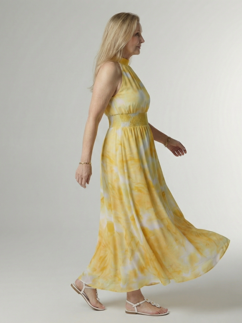 Flowy FJØRNA summer midi dress for women with halter neck and sleeveless design, perfect for warm weather.