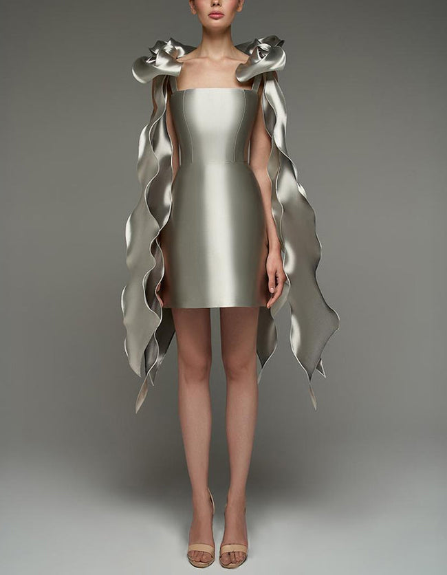 Silver satin cocktail dress by FJØRNA featuring a square neckline, strappy details, bodycon fit, and cape-style design.