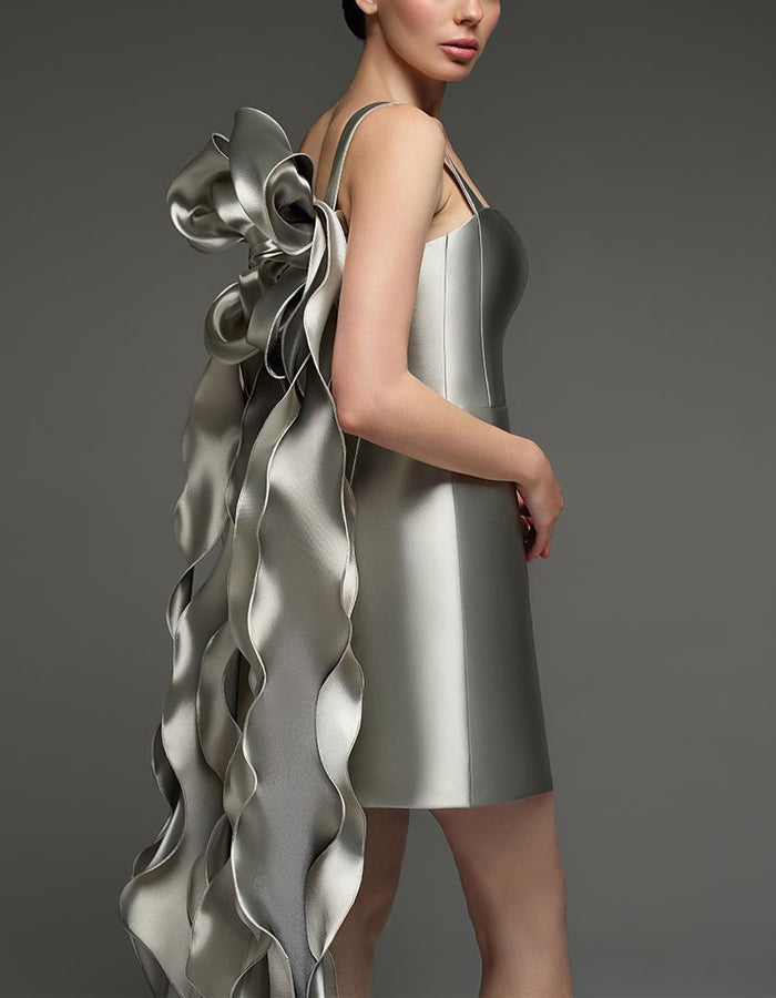 FJØRNA silver satin cocktail dress for women featuring a square neckline, bodycon fit, cape style, and strappy details.