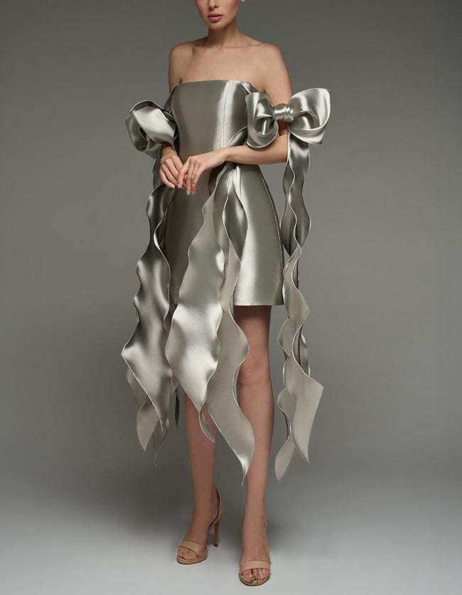 Silver satin cocktail dress by FJØRNA with square neckline, strappy details, and cape-style bodycon fit for women.