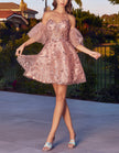 Black tulle cocktail dress for women with floral pattern and puff sleeves by FJØRNA, shown with detailed fabric and elegant design.