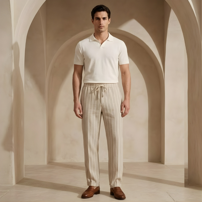 Men's linen trousers by FJØRNA with drawstring waist and relaxed fit, shown in natural light, highlighting breathable fabric and casual style.
