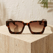 FJØRNA vintage rectangular unisex sunglasses with dark tinted lenses and black frames, accessory for women.