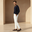 FJØRNA men's slim fit trousers, stylish and tailored pants, in a neutral color, displayed flat on a white background.