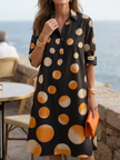 FJØRNA women's polka dot wrap summer dress displayed on a hanger, featuring short sleeves and a flattering fit.