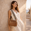FJØRNA leather shoulder bag for women, stylish and compact, featuring a smooth leather finish and adjustable strap.