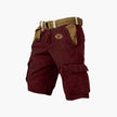FJØRNA men's cargo shorts with multiple functional pockets and ample storage, shown in a casual outdoor setting.
