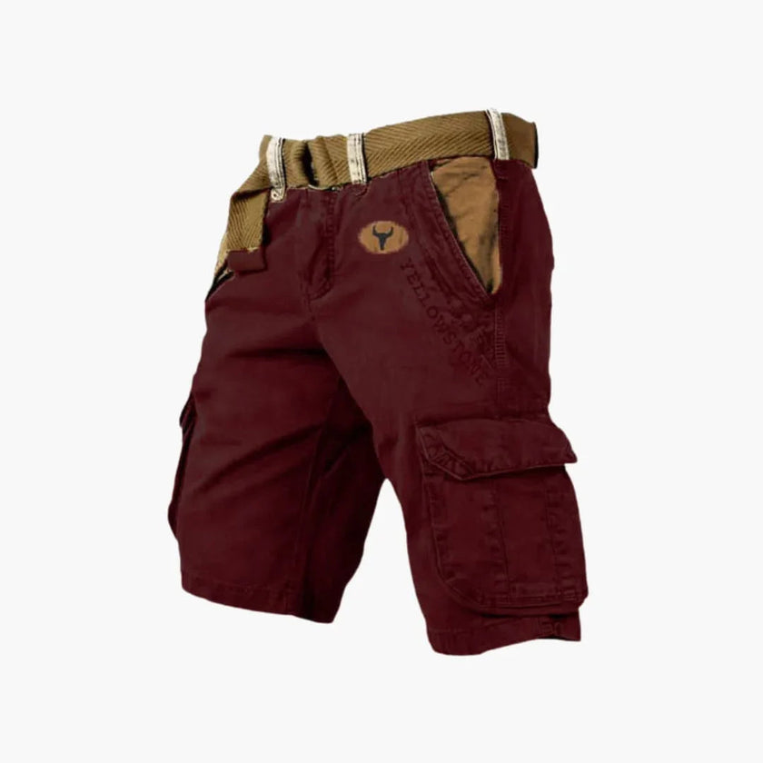 FJØRNA men's cargo shorts with multiple functional pockets and ample storage, shown in a casual outdoor setting.
