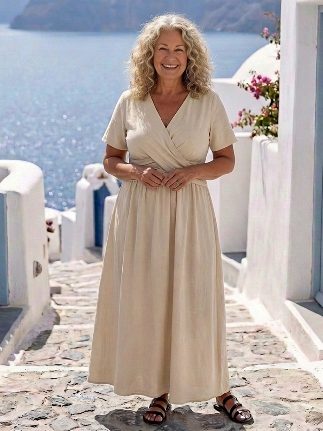 FJØRNA women's summer midi dress with v-neck, short sleeves, wrap style, flowy fabric, suitable for warm weather.