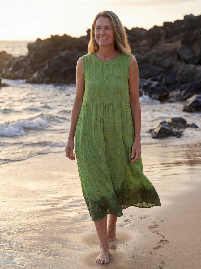 FJØRNA women's sleeveless summer midi dress, flowy and lightweight, ideal for warm weather, seen hanging on a hanger.