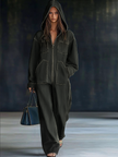FJØRNA casual loose retro denim jumpsuit with long sleeves, hood, zip front, and front pockets, styled for a relaxed look.