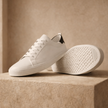 FJØRNA men's leather trainers shoes, stylish casual footwear with brown leather uppers and white rubber soles.