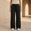 Women’s lightweight cotton wide leg trousers by FJØRNA, casual relaxed fit, natural color, showing the wide-leg design and soft fabric.