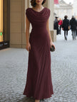 FJØRNA draped cowl-neck ruched maxi dress in flowing fabric, featuring elegant draping and a fitted silhouette.