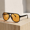 Unisex retro aviator sunglasses from FJØRNA with metal frames and dark lenses, stylish accessories for men and women.