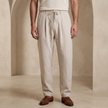 Men’s linen blend trousers by FJØRNA, lightweight casual summer pants in neutral color, tailored fit with relaxed style.