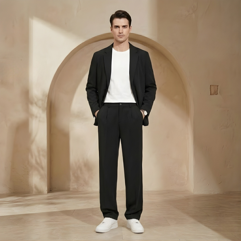 Pleated relaxed fit men's trousers by FJØRNA, showing the waistband and tailored design on a neutral background.