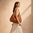 Large women's leather bag by FJØRNA, stylish and spacious tote with sturdy leather construction and natural brown finish.