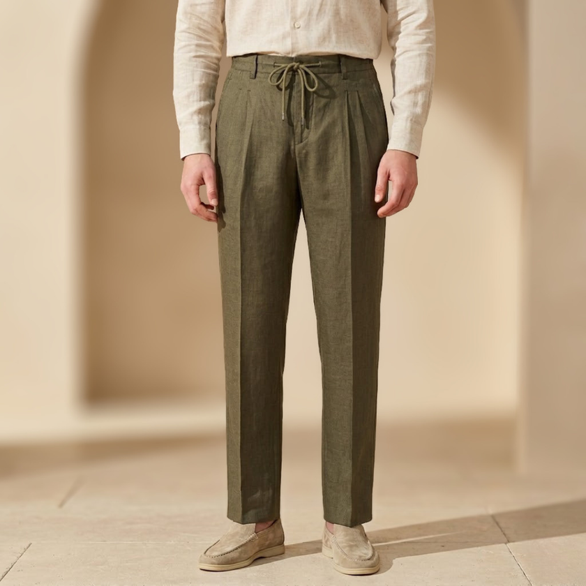Men's linen trousers by FJØRNA with drawstring waist and pleated design, shown in a relaxed fit style.