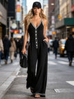 Black colour-block V-neck sleeveless jumpsuit by FJØRNA, featuring button-down front and stylish design.