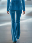 Blue loose velvet flared trousers for women by FJØRNA, showing the relaxed fit and elegant flare design.