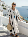 FJØRNA women's summer maxi dress with striped pattern, short sleeves, wrap design, flowy fabric, perfect for warm weather.