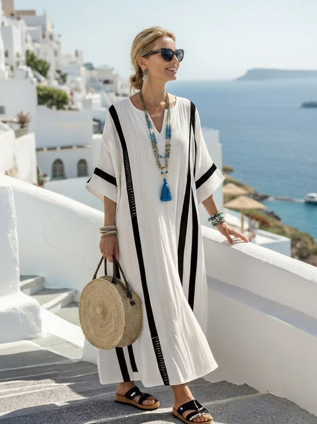 FJØRNA women's summer maxi dress with striped pattern, short sleeves, wrap design, flowy fabric, perfect for warm weather.