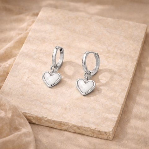 Silver FJØRNA White Quartz Heart Huggie Earrings for women, featuring heart-shaped white quartz stones and sleek hoop design.
