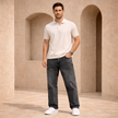 Relaxed fit men's denim jeans by FJØRNA, showing classic blue cotton pants with five-pocket design and casual style.