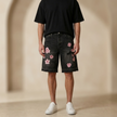 FJØRNA men's floral denim shorts with a relaxed fit, showcasing vibrant floral patterns and classic jean styling.